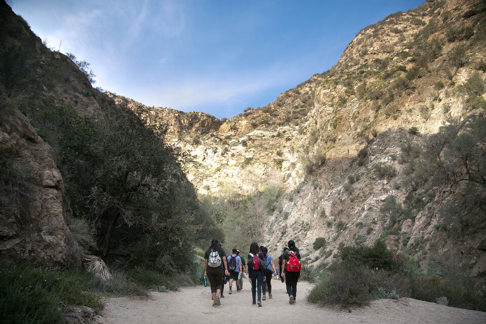 A group of hikers walks into a Southern California canyon.