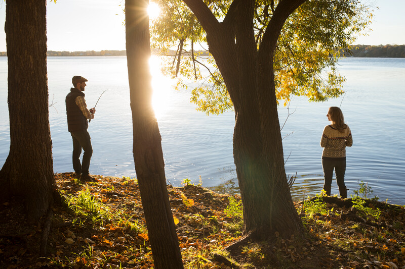 A man and a woman stand on the shore of the lake 