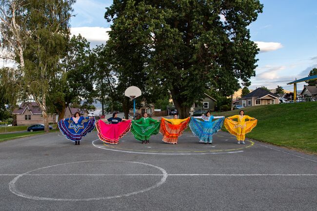 Women in colorful costume on a basketball court